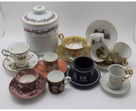 A collection of porcelain coffee / teacups & saucers, includes a Coalport one decorated with strawberries and butterflies, on