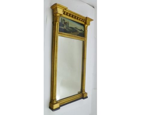 A 19TH CENTURY GILT FRAMED PIER MIRROR with inverted ball mounted crest over a reverse painted glass panel with landscape dec