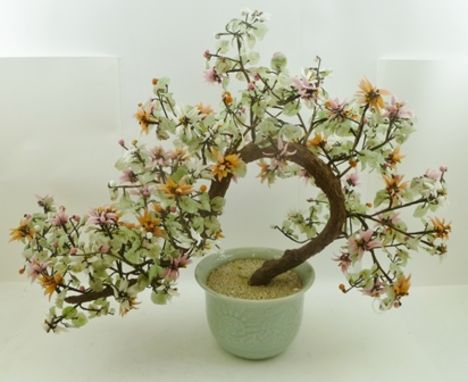 AN ORIENTAL BONZAI DESIGN BLOSSOMING TREE, constructed of polished hardstone leaves and blossoms on a wire armature in a cela