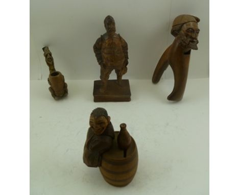 THREE ITEMS OF CARVED WOOD BLACK FOREST WARE, including a mask nutcracker, together with a figurative clay pipe (4) 
