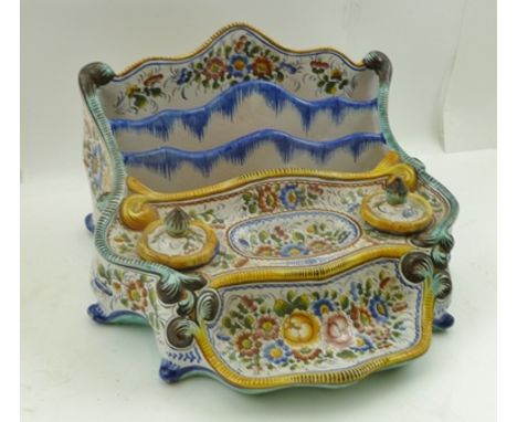 A CONTINENTAL FAIENCE DESK STAND, with stationery divisions, two ink wells with covers and pen recess, hand painted floral de