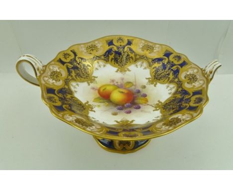 A ROYAL WORCESTER PORCELAIN COMPORT having gilded cobalt blue border, central hand-painted front panel signed A. Shuck, puce 