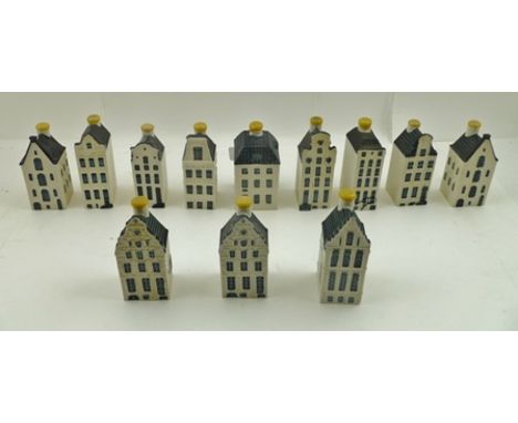 A COLLECTION OF TWELVE VARIOUS CERAMIC MODELS OF DELFT HOUSES made by KLM to contain Bols alcoholic drink, 11cm high 