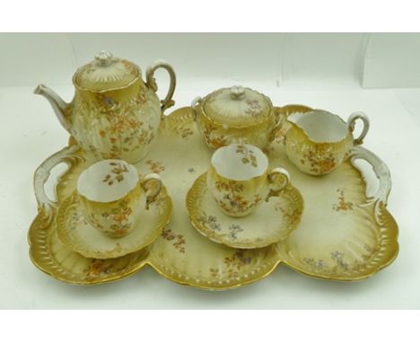 A LIMOGES PORCELAIN TEASET "a deux personnes", floral decorated, comprising; two handled tray, teapot, sugar bowl, jug and tw