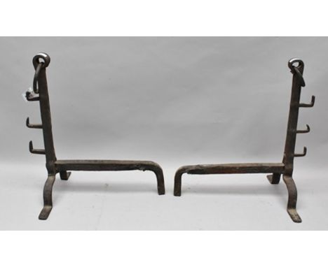 A PAIR OF WROUGHT IRON FIRE DOGS, 17th century design, with ring mounts, 58cm high 