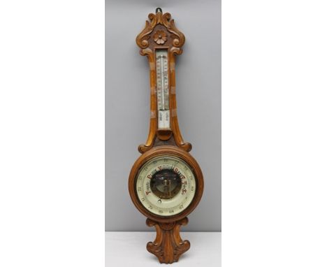 A FRENCH 19TH CENTURY CARVED OAK BACK WALL MOUNTABLE BANJO BAROMETER/THERMOMETER, with exposed workings, 83cm long 