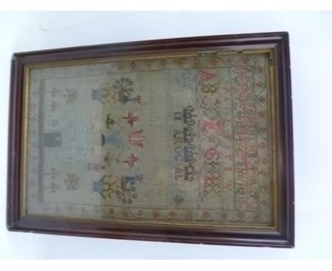 AN EARLY 19TH CENTURY NEEDLEWORK SAMPLER with alphabet, house, vases of flowers and exotic birds, dated 1811, 40cm x 25cm in 