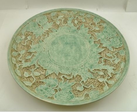 A RADFORD POTTERY CHARGER, decorated in a Japonaise floral design, glazed in a jade colour, 41cm diameter 