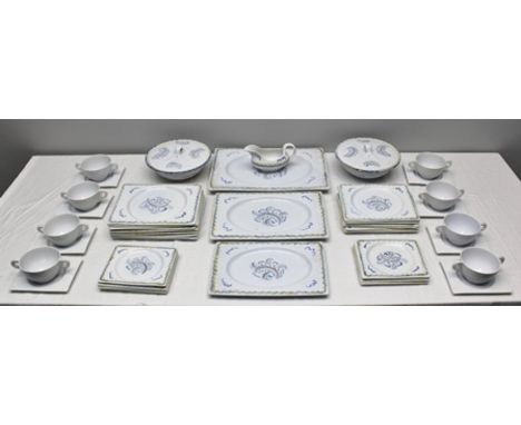 A CLARICE CLIFF "BIZARRE" PATTERN DINNER SERVICE, designed by Gordon Forsyth R.I., hand-painted blue leaf design with yellow 