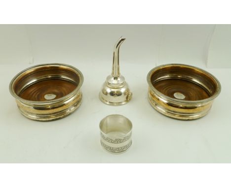 A PAIR OF GEORGIAN DESIGN OLD SHEFFIELD PLATE BOTTLE COASTERS with turned wood bases, a PLATED WINE FUNNEL, and a SILVER NAPK