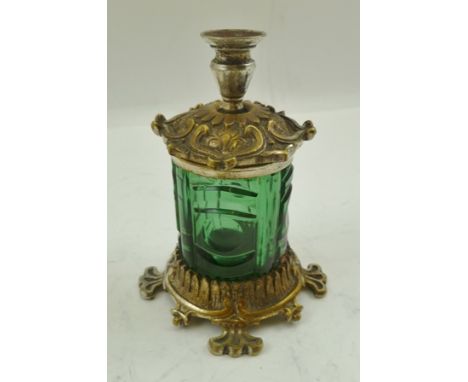 A LATE VICTORIAN ELECTRO-PLATE MOUNTED GREEN GLASS INKWELL with taper stick on a decorative cover, 9cm high 