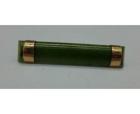 A jade brooch with 9ct gold mounts