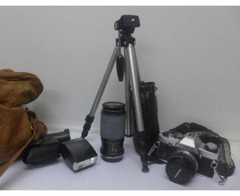 An Olympus OM10 film camera, lenses and tripod