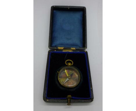 A brass compass, cased