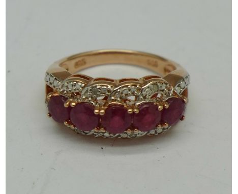 A silver gilt, ruby and diamond ring, L