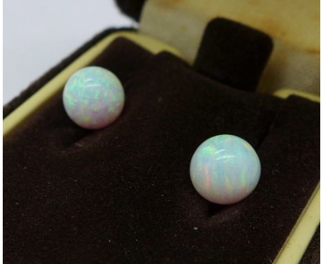 A pair of globular opal ear studs, diameter 8mm