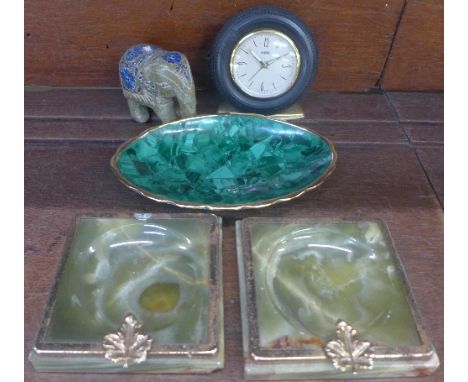 A malachite navette shaped dish, a pair of onyx and gilt metal ashtrays, a carved onyx and lapis lazuli elephant and a West G