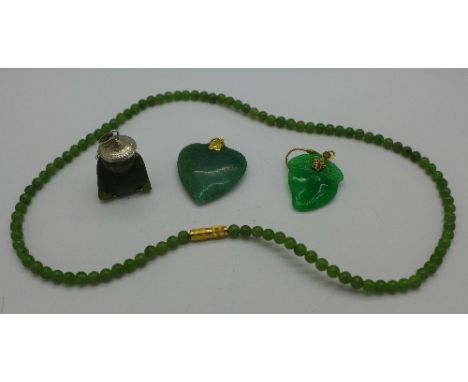 A jade necklace, two pendents and a single earring