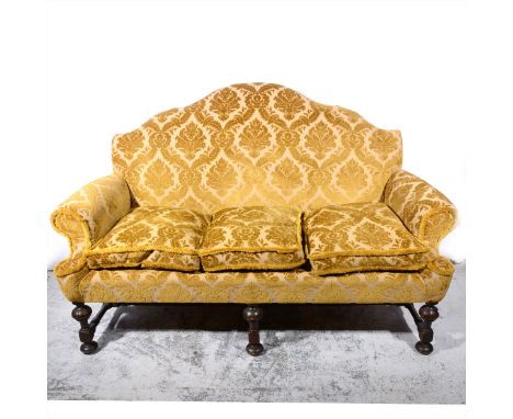 Sofa of 18th Century design, upholstered in sculptured Old Gold velour, turned walnut legs, length 190cm.