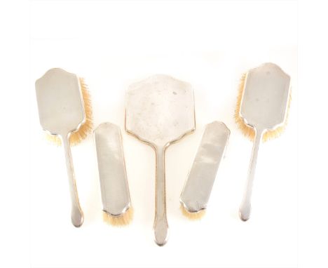 A silver-backed dressing table set, W G Sothers Ltd, Birmingham 1931, comprising hand mirror and four brushes, engine turned 