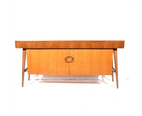 A Lebus teak veneered mid-century sideboard, fitted with three frieze drawers, over two doors, length 168cm.