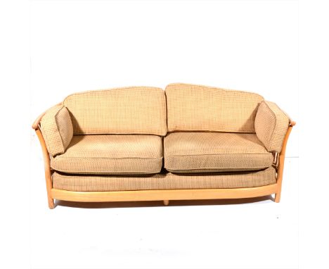 An Ercol pale ash sofa, vertical rails to the back and arms, length 183cm.