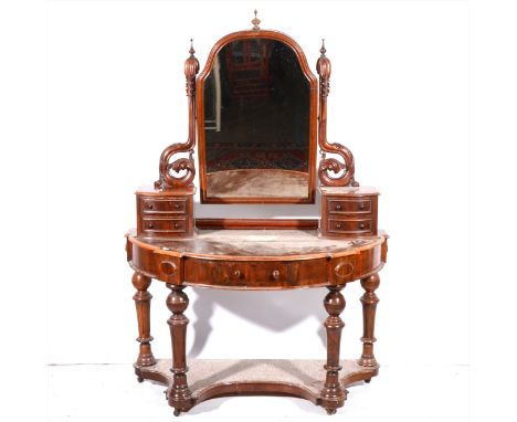 A Victorian mahogany Duchess dressing table, arched mirror back, with scrolled brackets, fitted with two banks of two bowfron