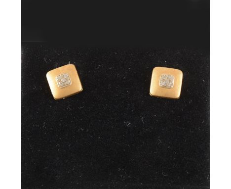 A pair of 14k satin finish earrings, synthetic white stones to centre, pierced fittings with post and butterfly.