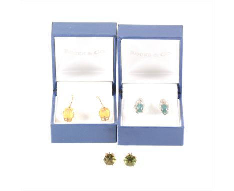 A pair of blue cat's eye and clear stone earrings, the cabochon cut blue stone four claw set, stylised leaf design and two cl