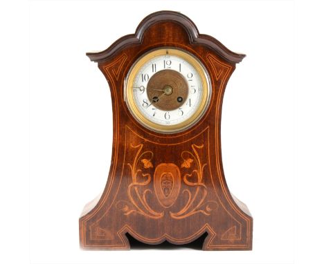 An Edwardian 8 day mantel clock, mahogany case inlaid with Art Nouveau inspired floral design and a centralised mask, French 