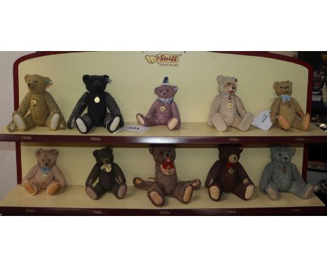A collection of ten 'Century of Steiff' porcelain bears with buttons in ears and jointed limbs, with display shelf