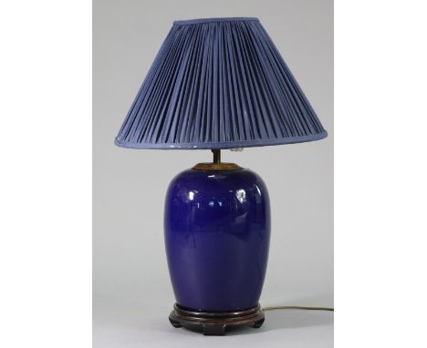 A Chinese porcelain blue-glazed ovoid vase table lamp on hardwood stand, 27” high over-all.