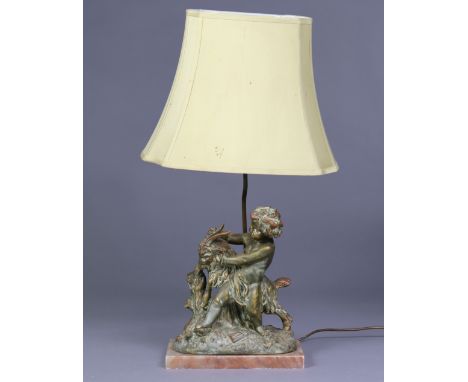 A 19th century style cast metal table lamp in the form of a putto taming a ram, on rouge alabaster rectangular base, with sha