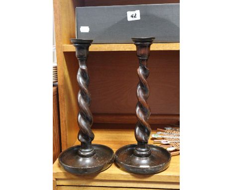 A mid-20th century mantel clock, in an oak case, 12” high; a pair of barley-twist oak candlesticks, 12” high; three decorativ