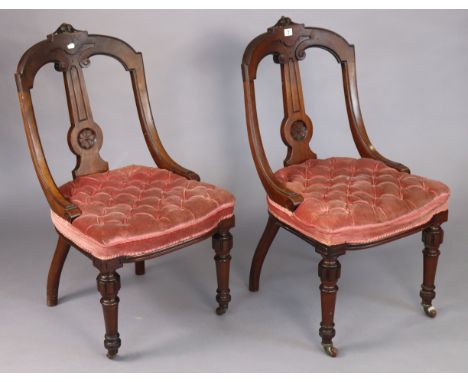 A pair of 19th century Athenian-style carved mahogany dining chairs each with a buttoned seat &amp; on turned tapered legs wi