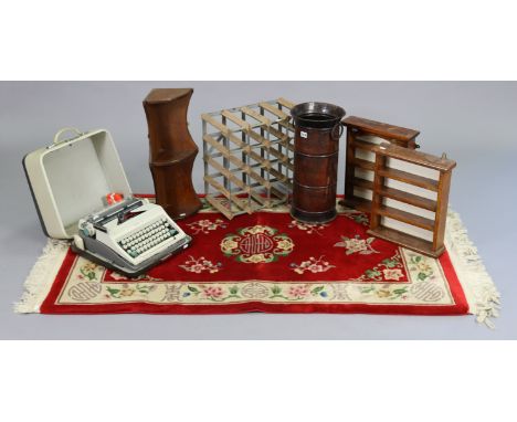 A sixteen-division wine-rack; a modern Chinese rug; an umbrella stand; three small wall shelves; &amp; a portable typewriter.