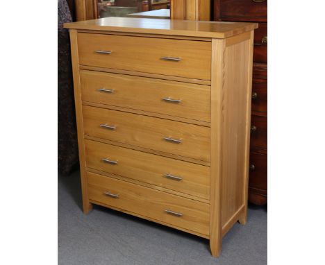 A light oak chest fitted five long drawers with silvered-metal handles, 37¾” wide x 46¼” high x 16¾” deep.