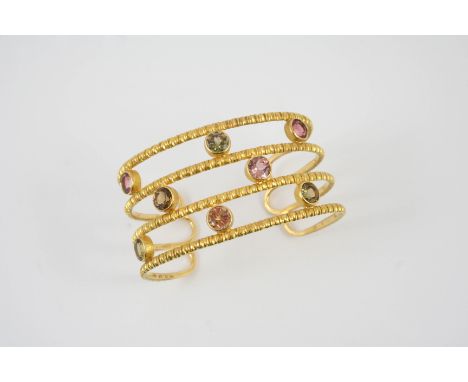 A CITRINE, QUARTZ AND GOLD BANGLE BY LALAOUNIS the 18ct gold openwork bangle is mounted with circular-cut citrines and quartz