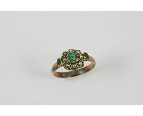 A VICTORIAN EMERALD AND PEARL RING set with three graduated emeralds and half pearls, in gold. Size R