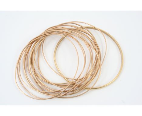FIFTEEN 9CT GOLD BANGLES 46 grams, together with a single gold bangle, 7.0 grams