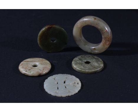 CHINESE CELADON JADE RING OR SMALL BANGLE, carved in low relief with a dragon head, diameter 6.5cm; together with four discs 