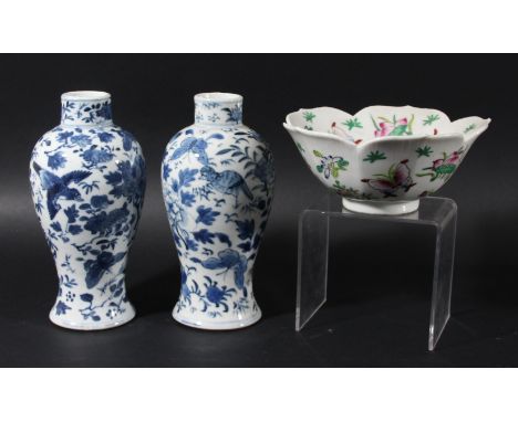 TWO CHINESE BLUE AND WHITE VASES, Kangxi mark but later, of inverted baluster form, painted with birds and foliage, four char