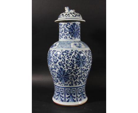 CHINESE BLUE AND WHITE BALUSTER VASE AND COVER, Kangxi style, painted with flowerheads amongst scrolling foliage, drilled, he