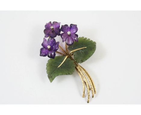 A JADE AND AMETHYST FOLIATE SPRAY BROOCH the three amethyst flowerheads each centred with a circular-cut diamond, with nephri