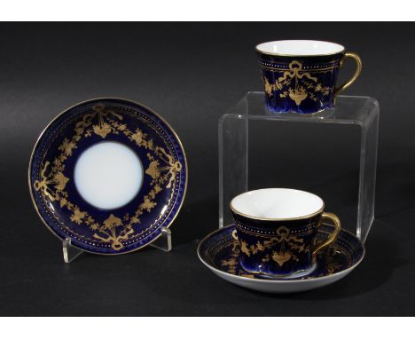 PAIR OF RUSSIAN PORCELAIN CUPS AND SAUCERS, Gardner Factory, with gilt floral swags on a dark blue ground, iron red printed m