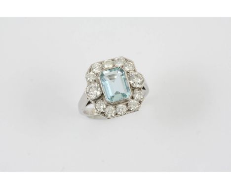 AN AQUAMARINE AND DIAMOND CLUSTER RING the step-cut aquamarine is set within a surround of two circular-cut diamonds and ten 