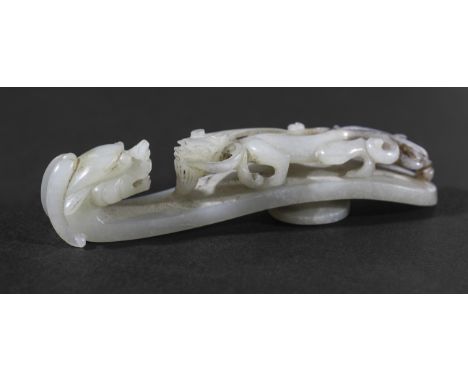 CHINESE GREY OR PALE CELADON JADE BELT HOOK, carved with a scrolling chilong and a winged, dragon head, length 9.5cm