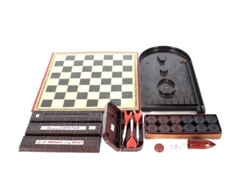 A collection of Bakelite items including three bridge boards, a set of interlocking draughtsmen pieces, chess and draught boa