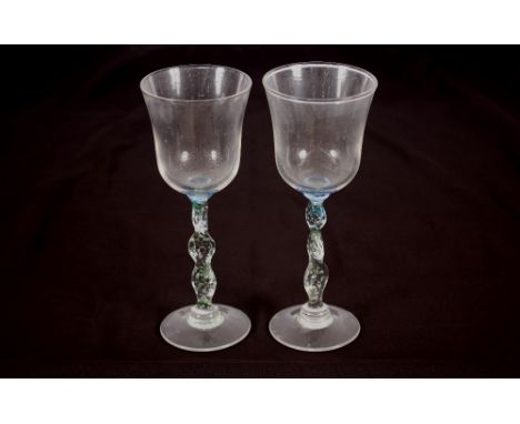A pair of Art Glass wine glasses indistinctly signed to base, 21cm high 