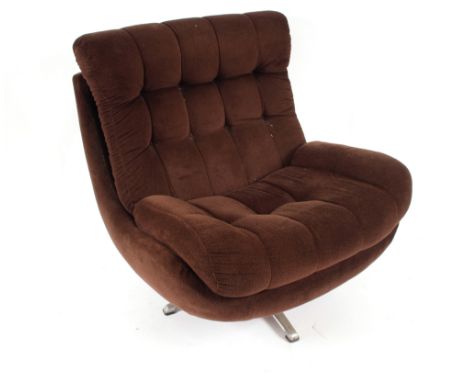 An S. Engender &amp; Sons Ltd, button down upholstered lounge chair raised on revolving base